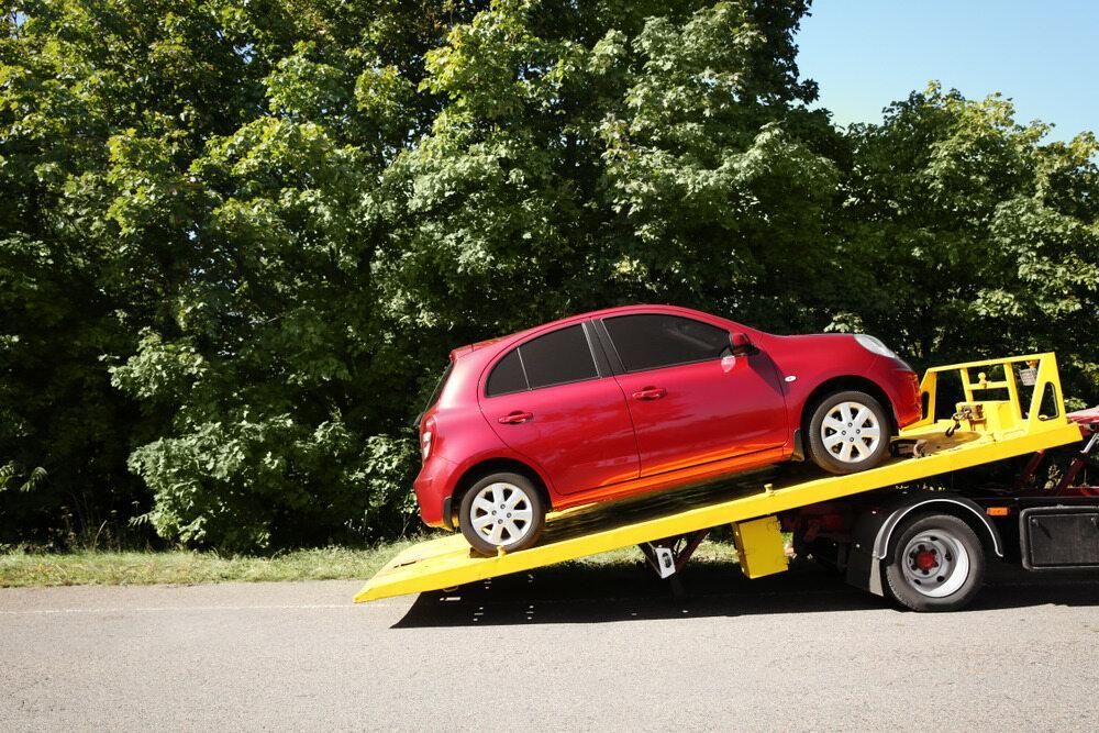 A Red Car is Being Towed by a Tow Truck — Bulahdelah Towing In Bulahdelah, NSW
