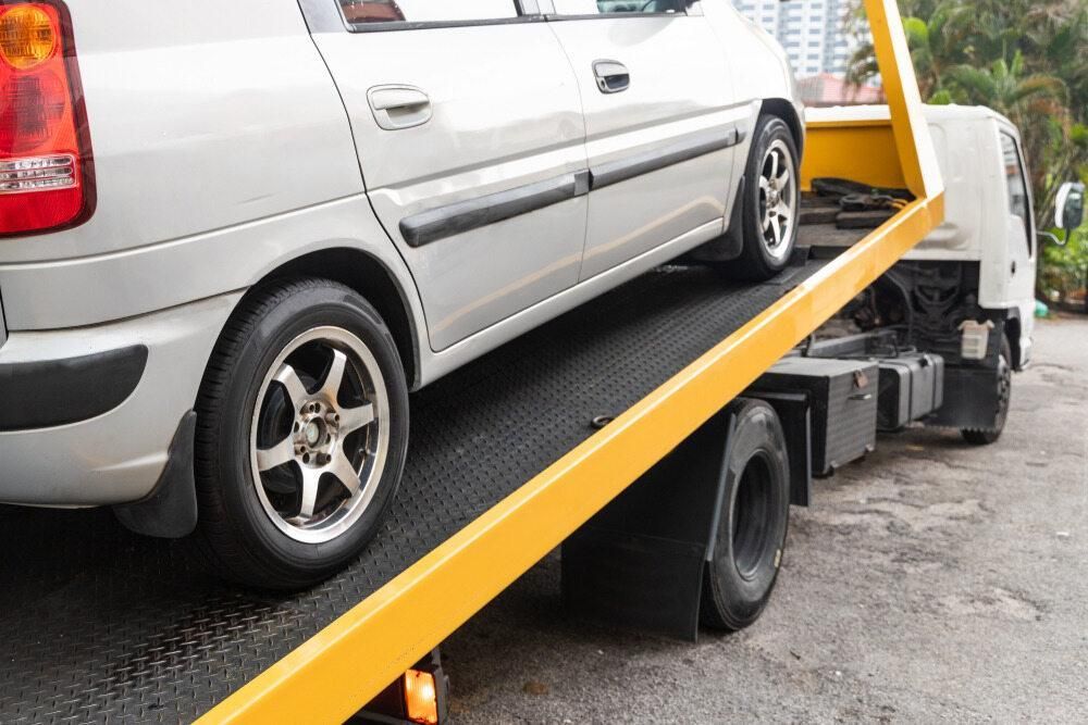 A Car is Being Towed by a Tow Truck — Bulahdelah Towing In Stroud, NSW