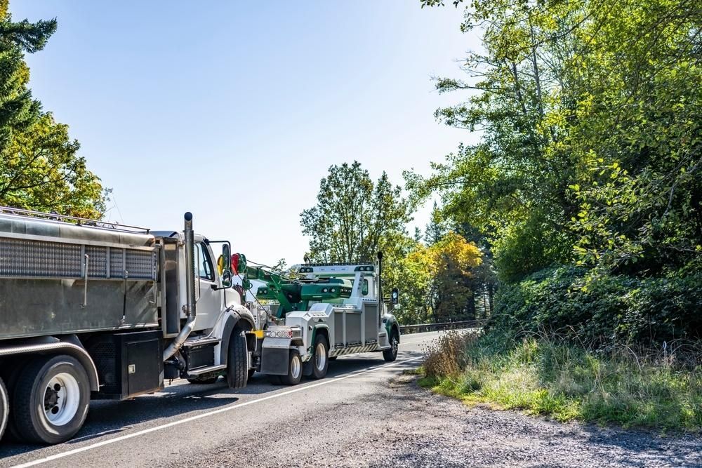 Two Dump Trucks Are Parked on the Side of a Road — Bulahdelah Towing In Coolongolook, NSW