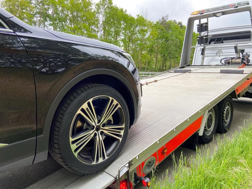 A Car is Being Towed by a Tow Truck — Bulahdelah Towing In Karuah, NSW