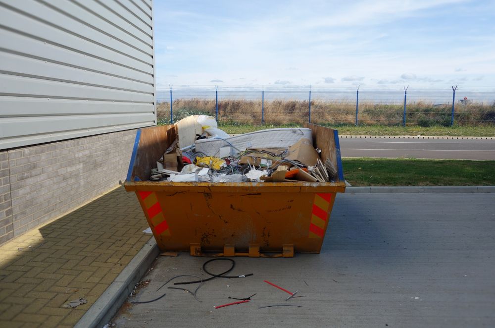 Orange Dumpster Filled With Trash — Tamworth Skips and Rubbish Removal in South Tamworth, NSW