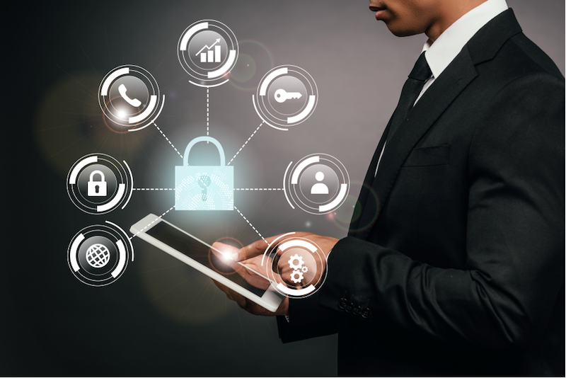 A man in a suit is using a tablet with a padlock on it.
