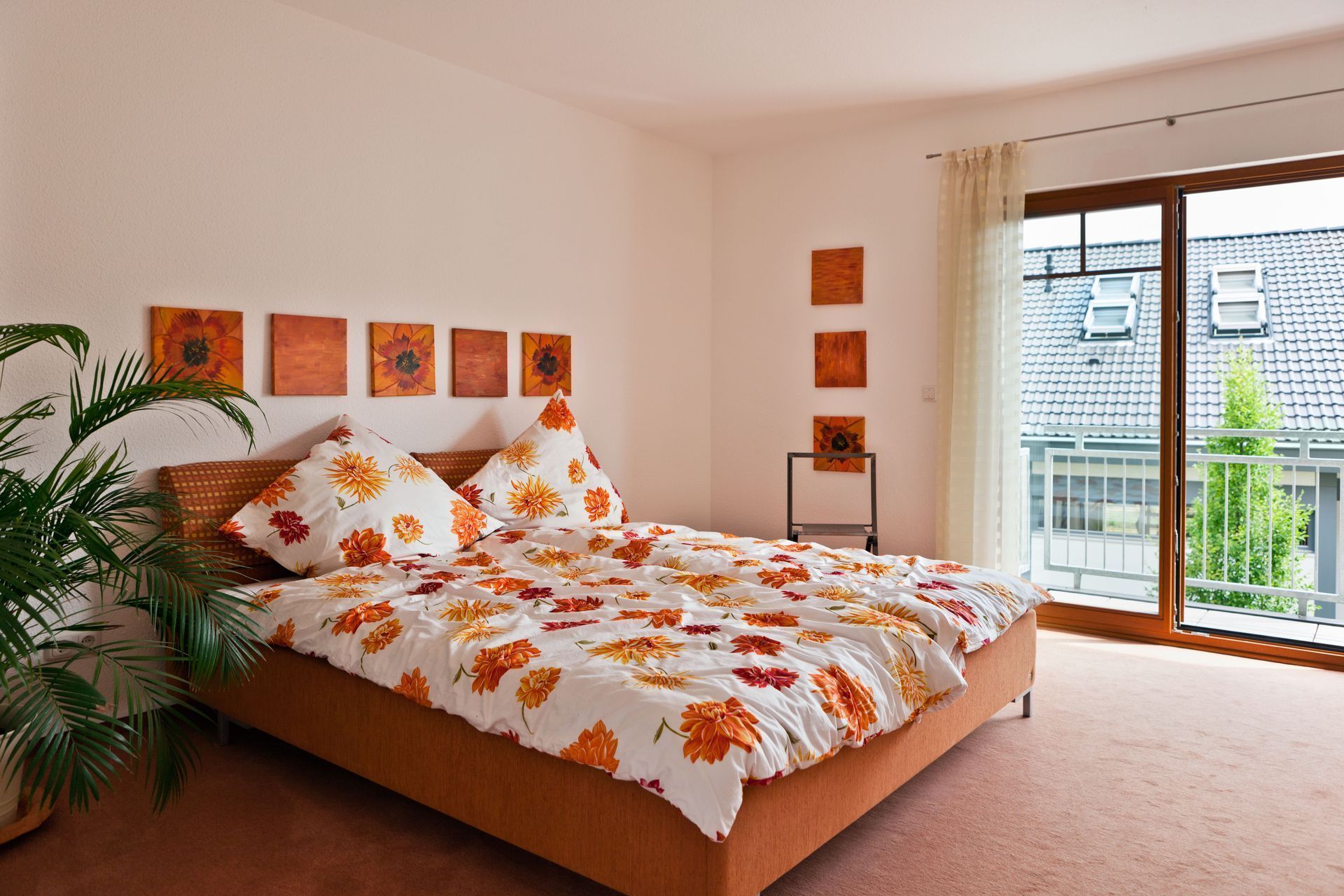 A bedroom with a large bed and a balcony