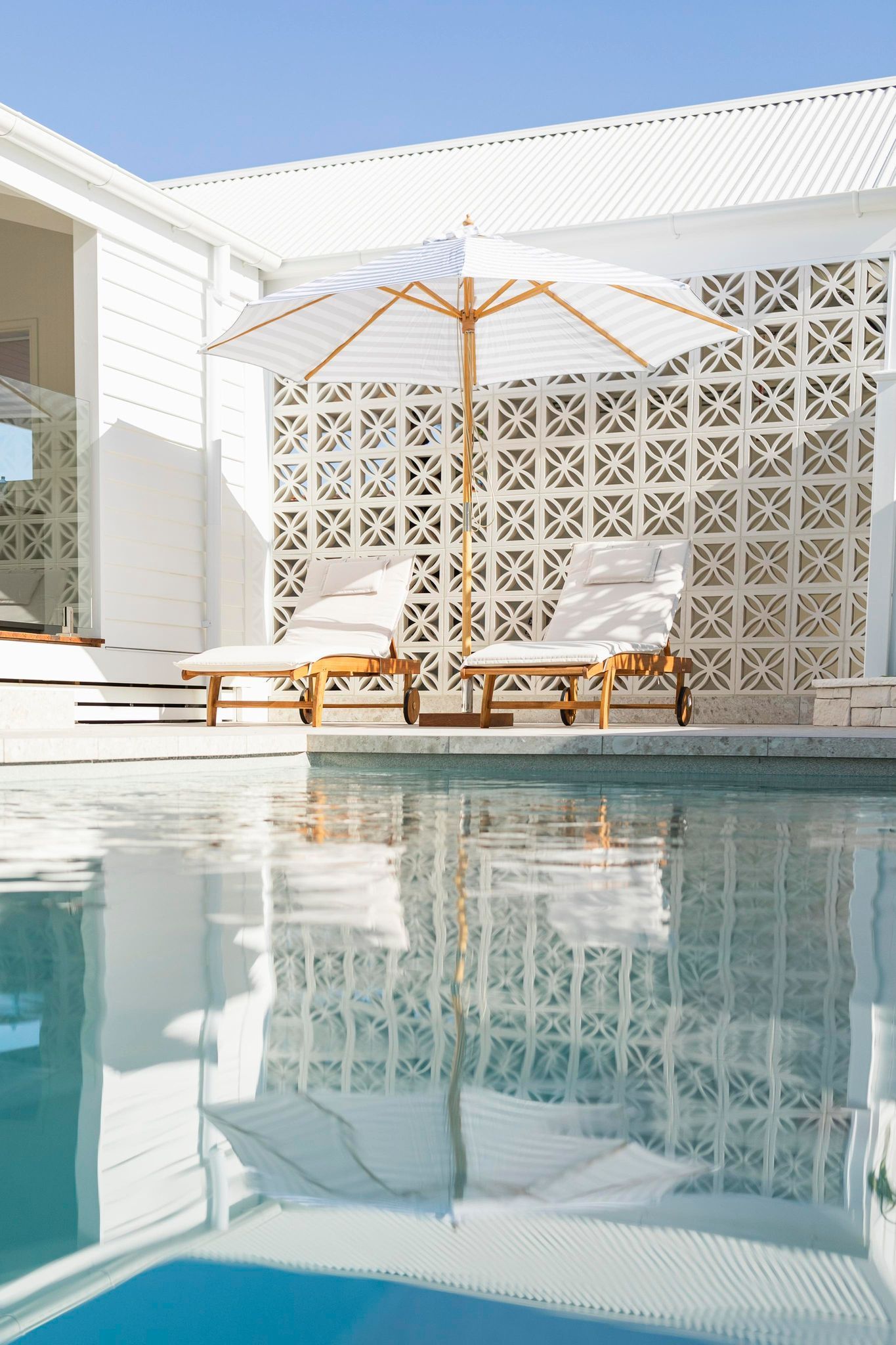 Poolside Scene: White Loungers and Umbrella — Swan Hill Pool & Spa Centre in Swan Hill, VIC