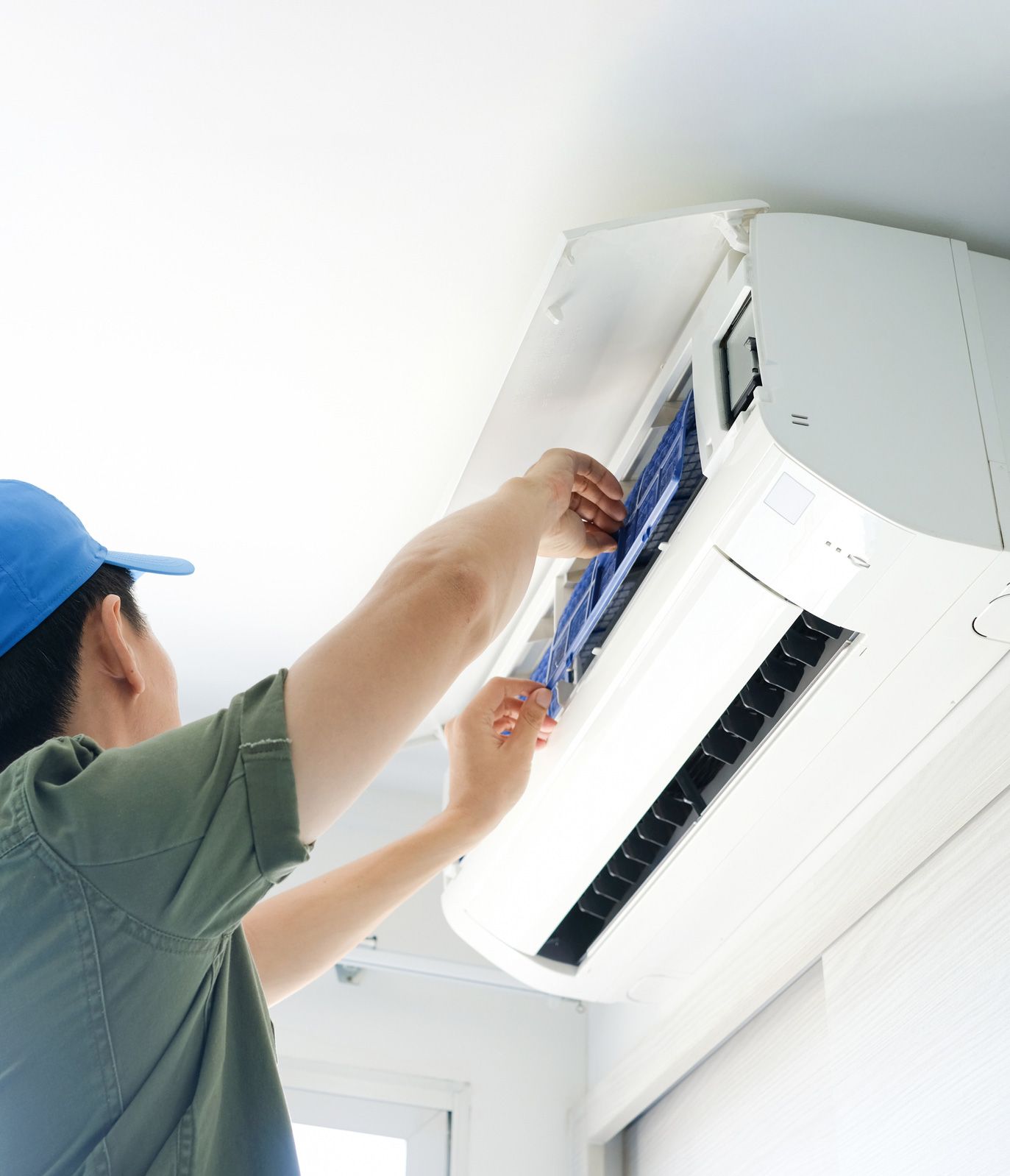 Male Repairing Air Conditioner — Randleman, NC — Evans Air Services Inc. Male Repairing Air Conditioner — Randleman, NC — Evans Air Services Inc.