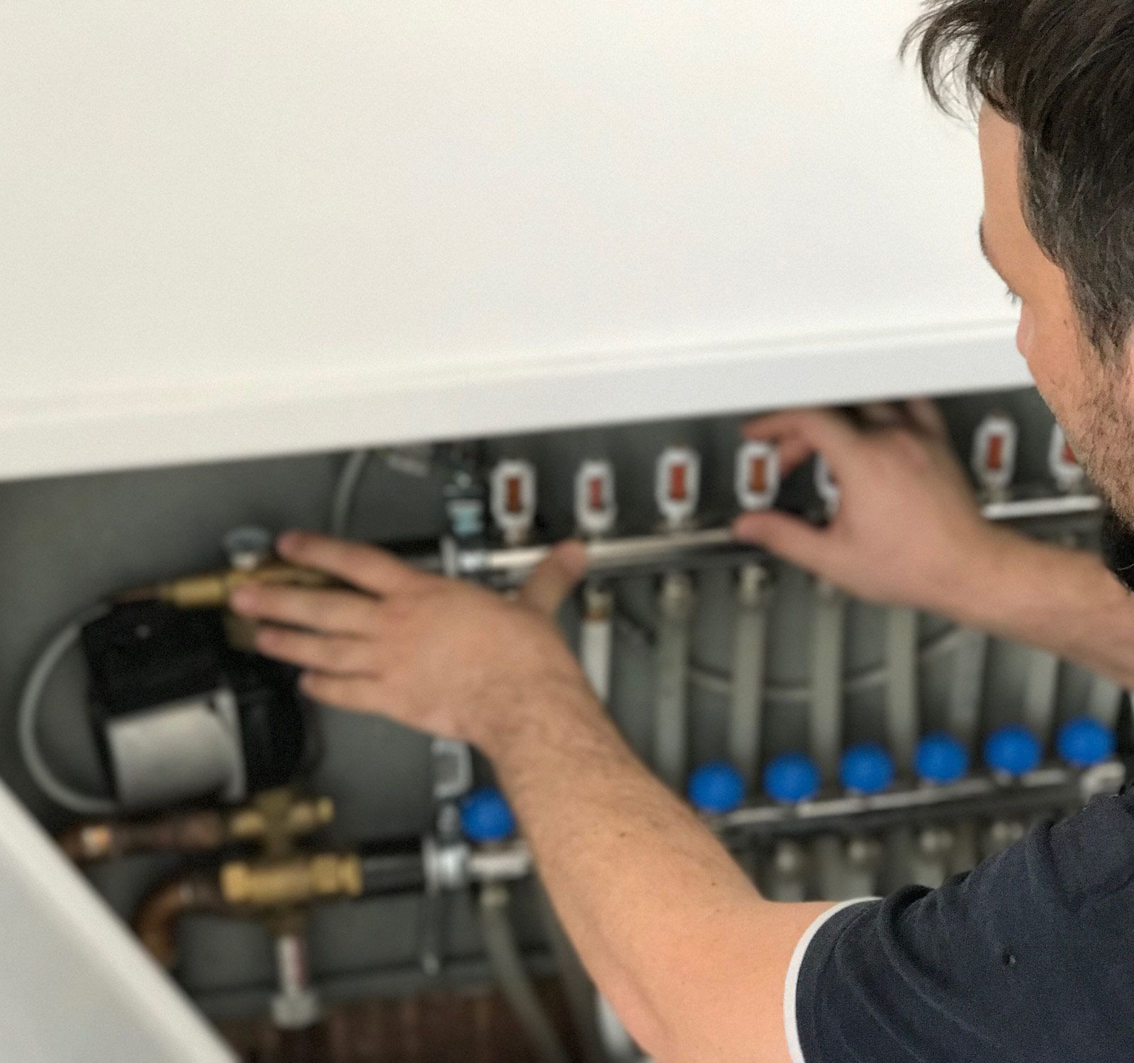 Man Checking Heating System — Randleman, NC — Evans Air Services Inc. Man Checking Heating System — Randleman, NC — Evans Air Services Inc.