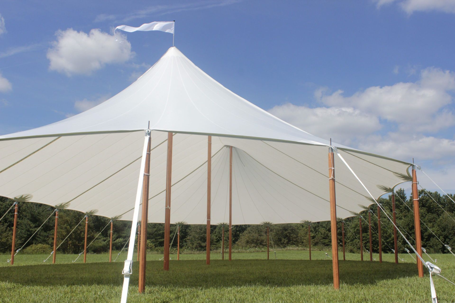 A Large White Tent is Sitting in the Middle of a Grassy Field
