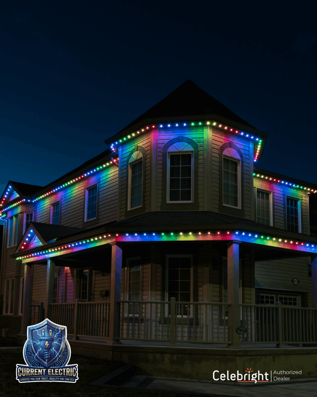 Two-story house decorated with colorful rainbow Christmas lights at night