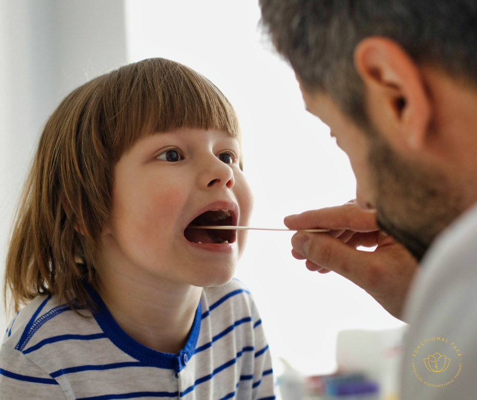 ENT and throat doctor assesses a child's tonsils