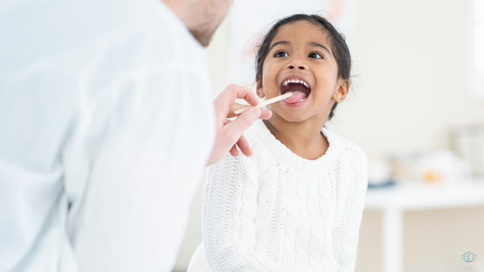 Child getting her tonsils examined by a doctor.