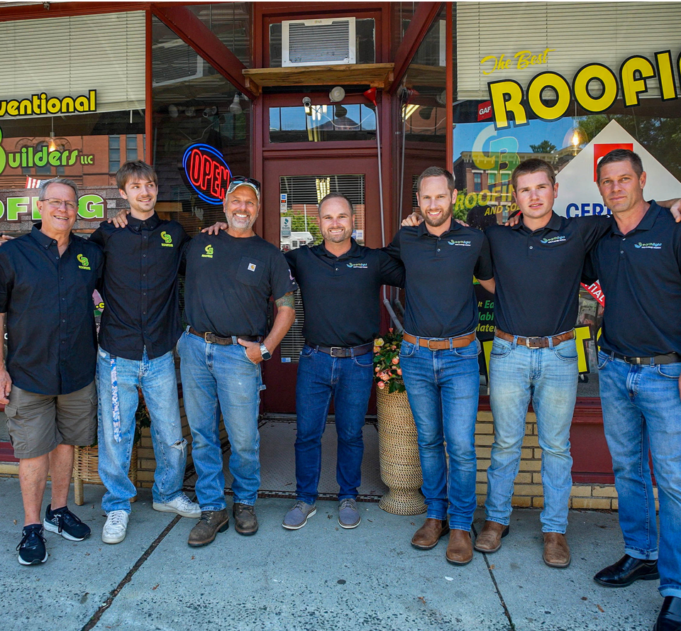 Six men in black shirts and jeans stand outside a storefront with an OPEN sign.
