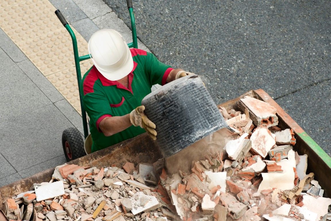 man dumping construction waste