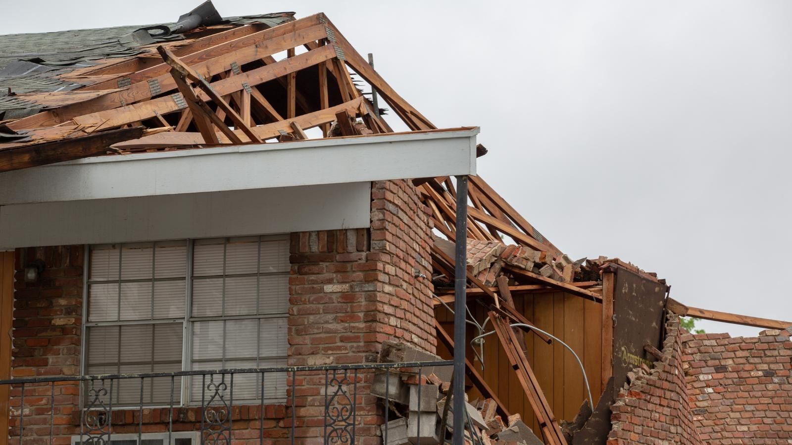 home repair tax deductible claims A brick house with a roof that has been damaged by a tornado.