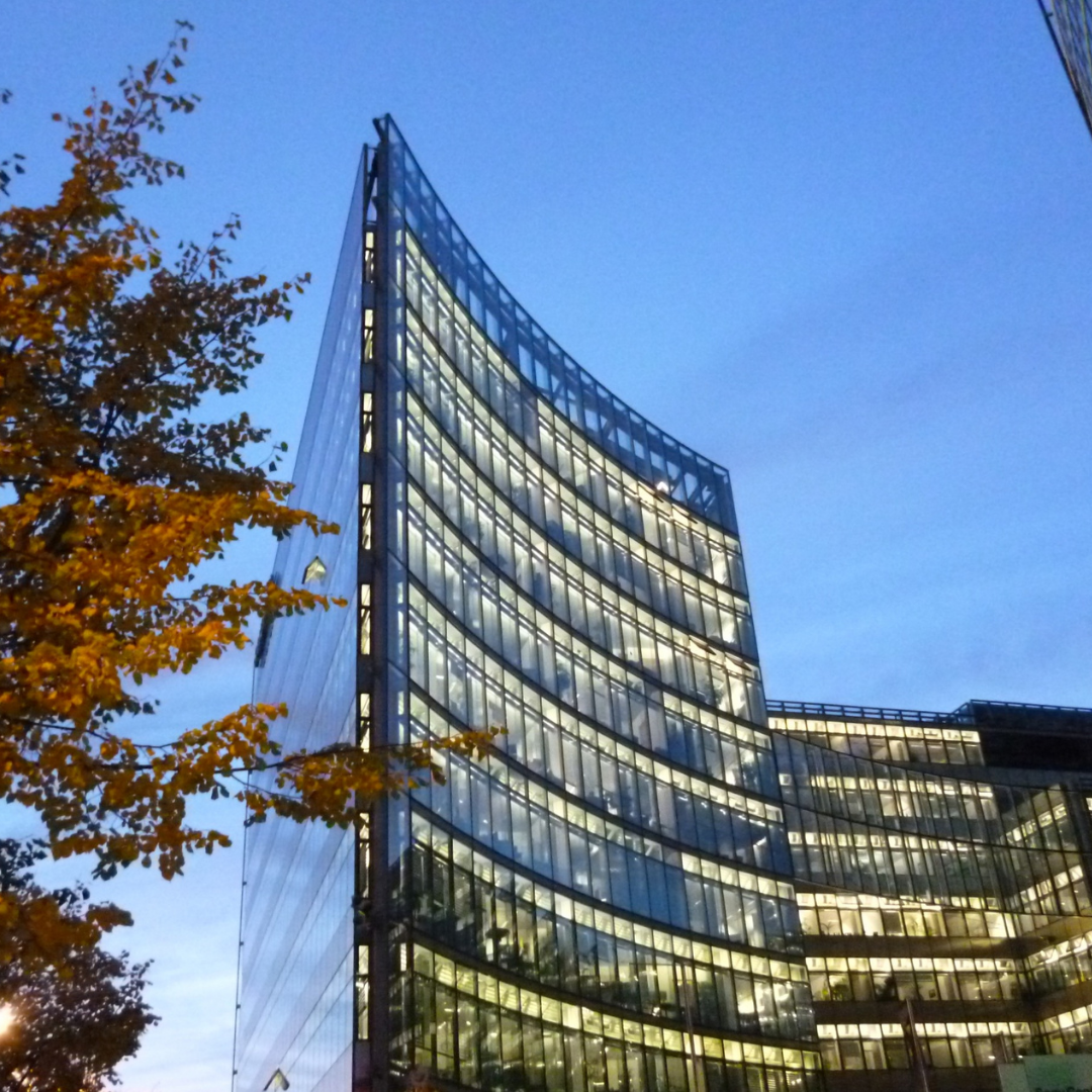 A building with a lot of windows is lit up at night