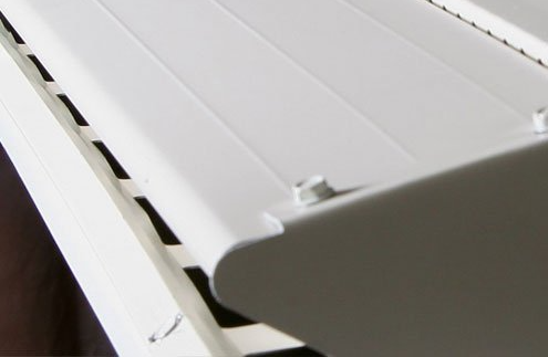 A close up of a white piano keyboard with black keys