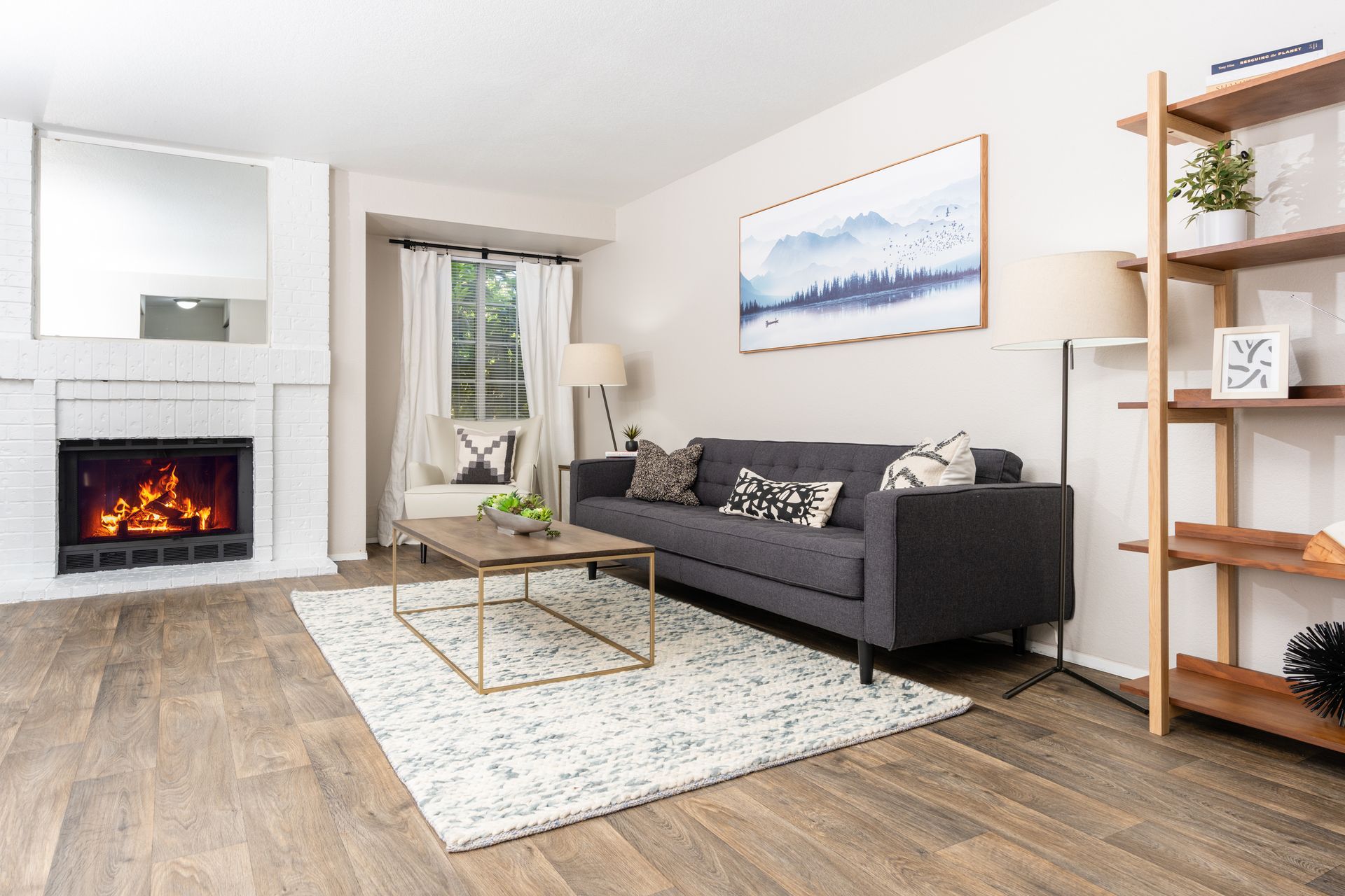 A living room with a couch , coffee table and fireplace.