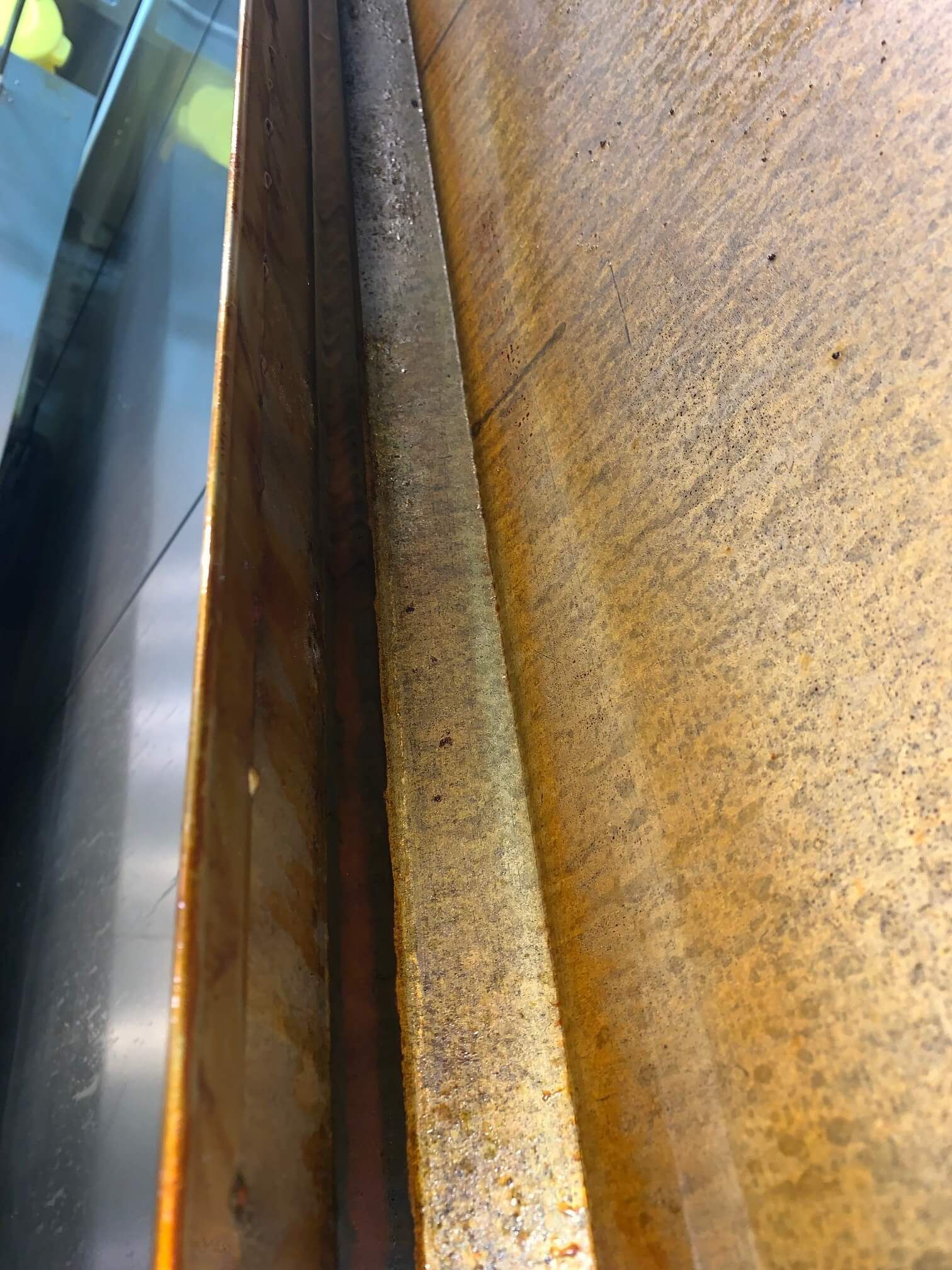 A close up of a rusty piece of metal.