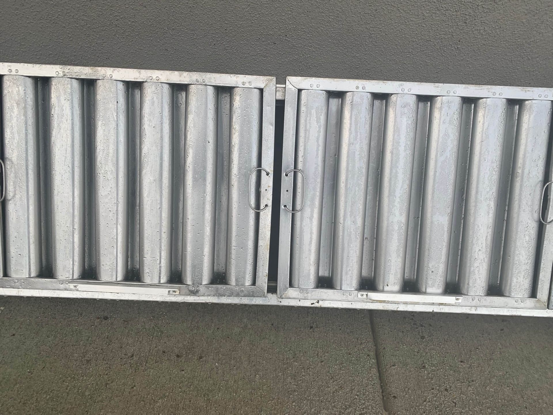 A metal grille is sitting on a concrete surface