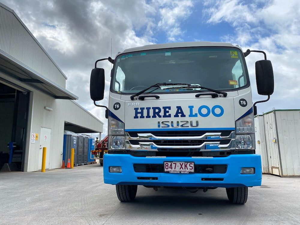 A Hire a Loo Truck is Parked in Front of a Building — Hire A Loo in Nambour, QLD