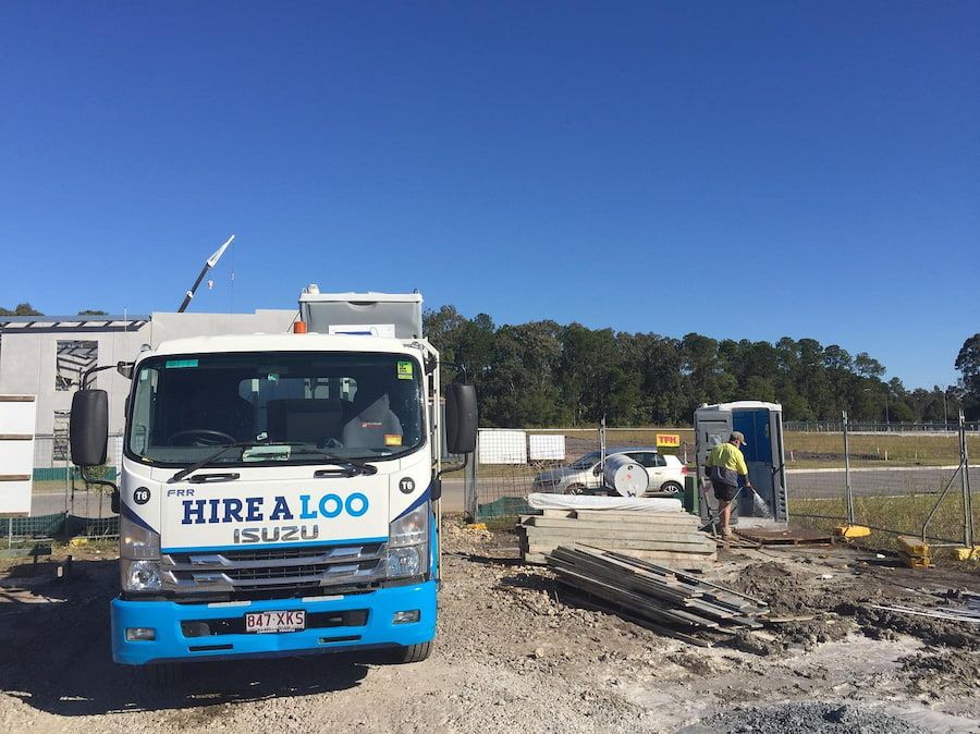 A Hire a Loo Truck is Parked in a Dirt Lot — Hire A Loo in Coolum Beach, QLD