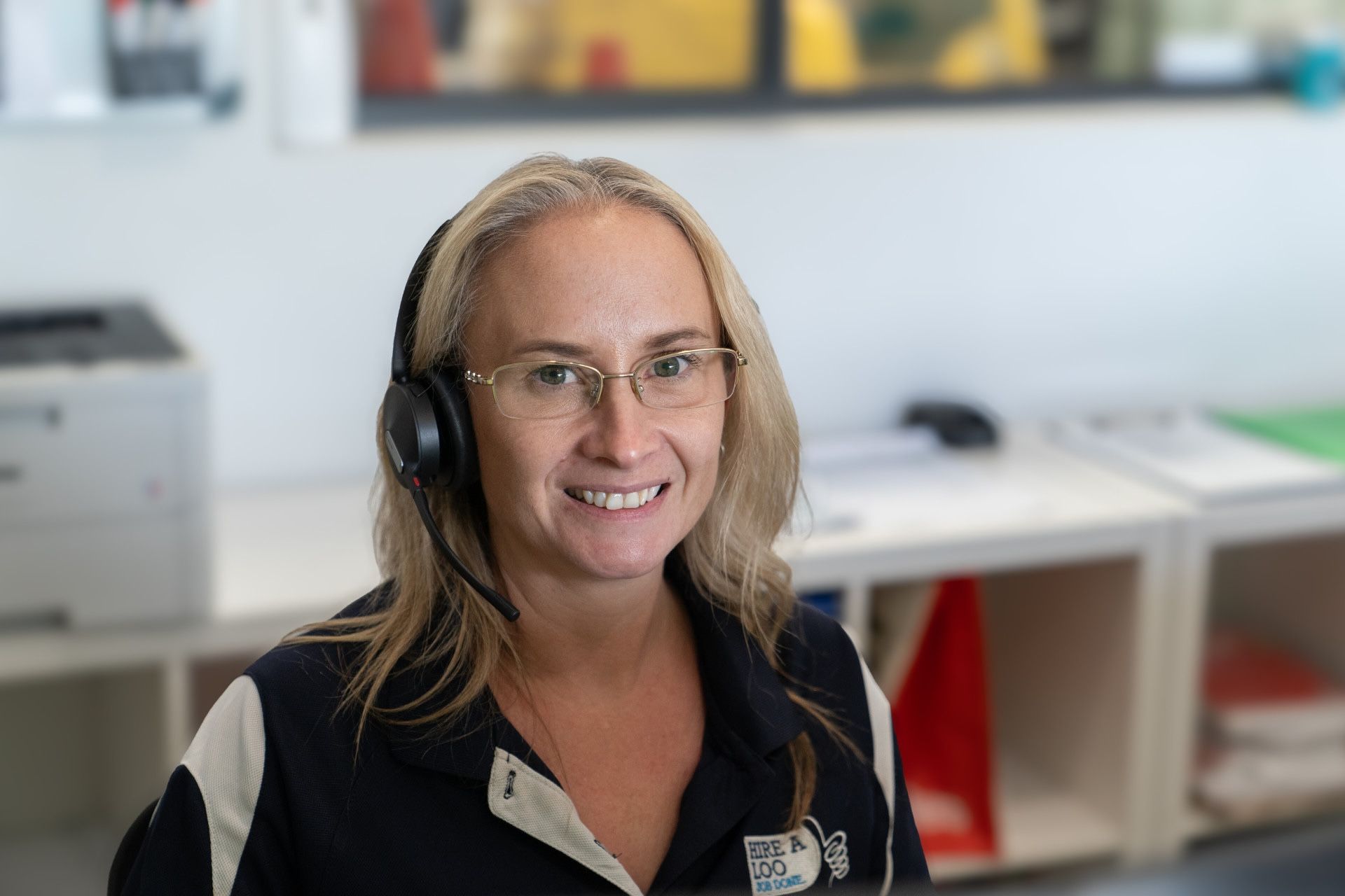 Lady With Phone Headset Smiling — Hire A Loo in Coolum Beach, QLD