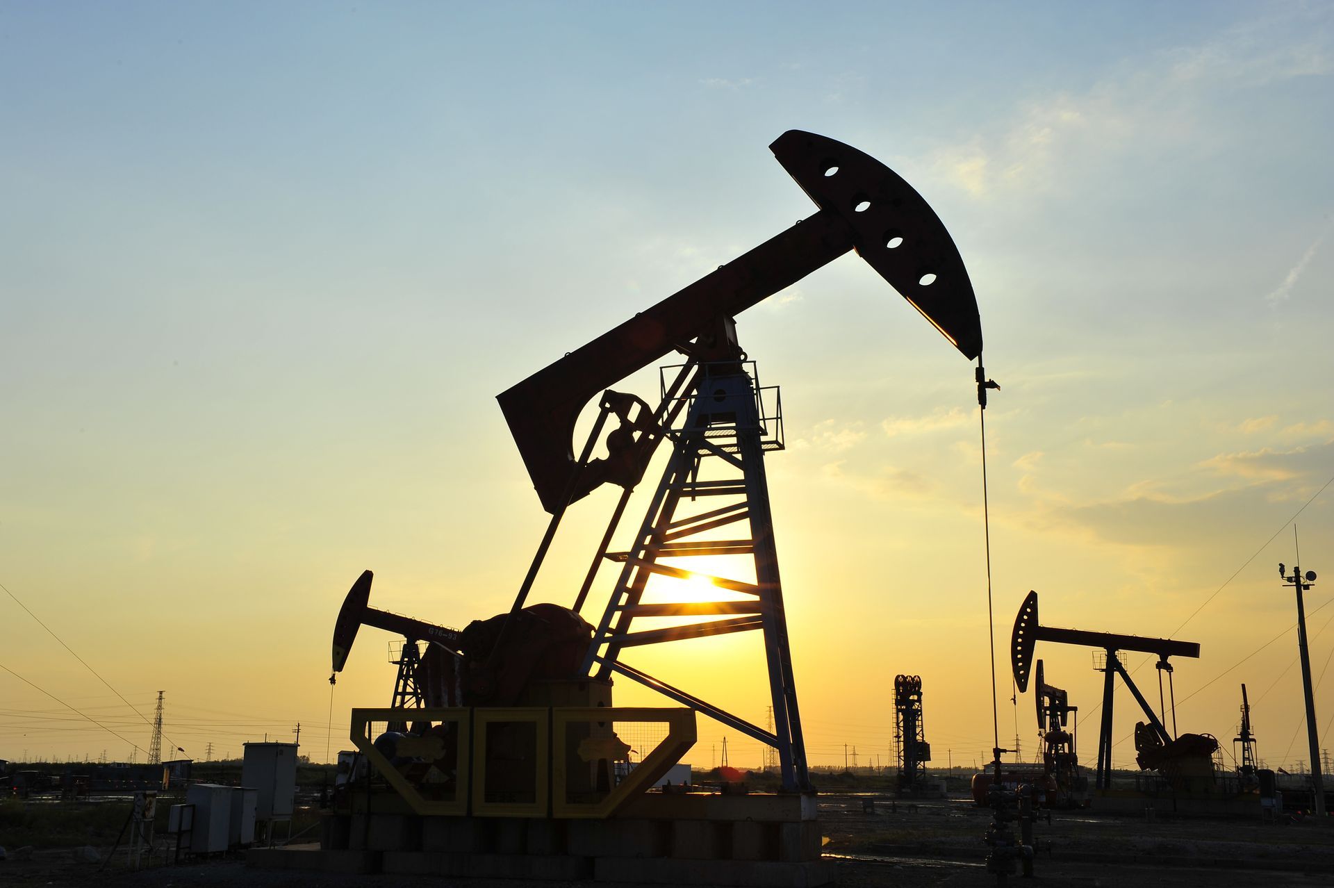 Oil pumps silhouetted against a setting sun