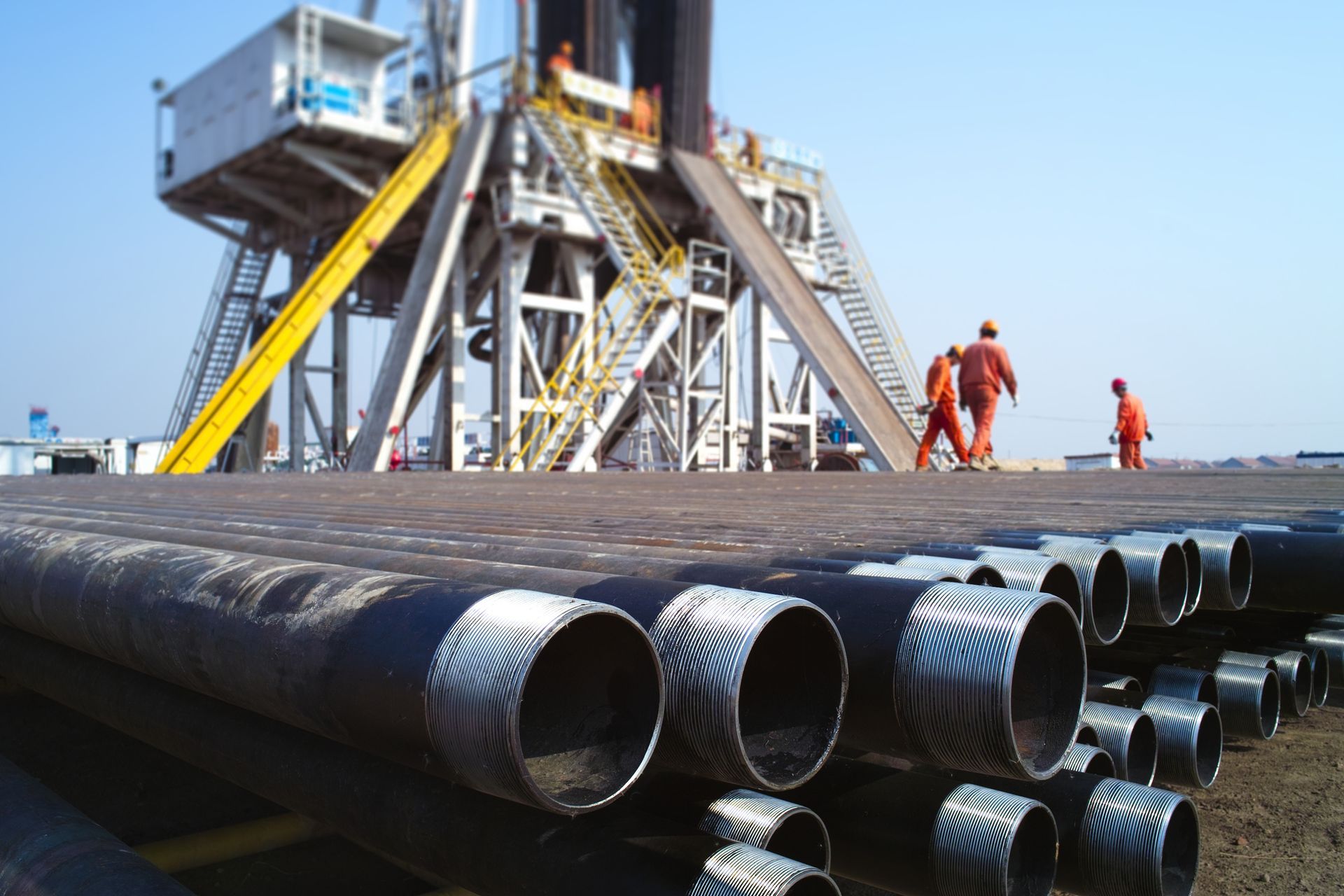 Oil pipes stacked near an oil rig