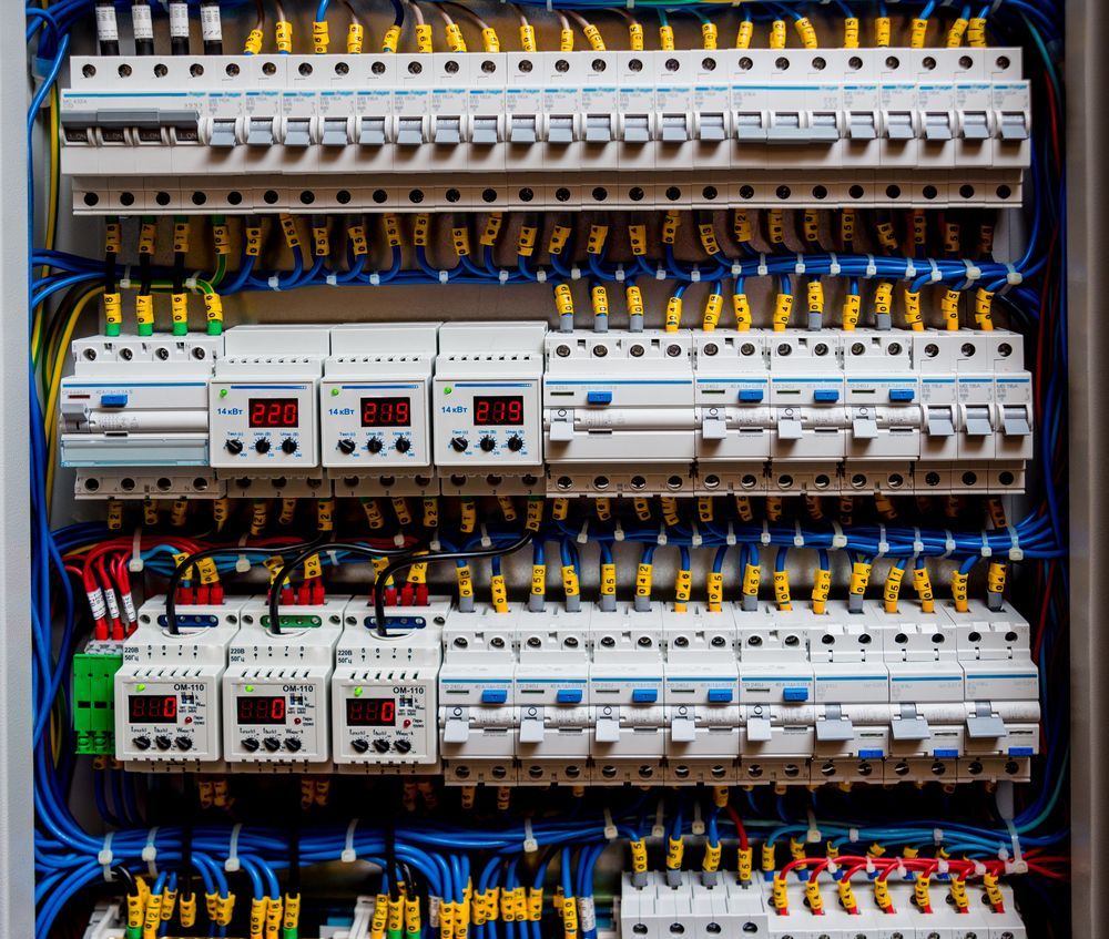 Electrical Panel With Numerous Circuit Breakers, Wires, and Digital Timers — FAW Electrical in Southern Highlands, NSW