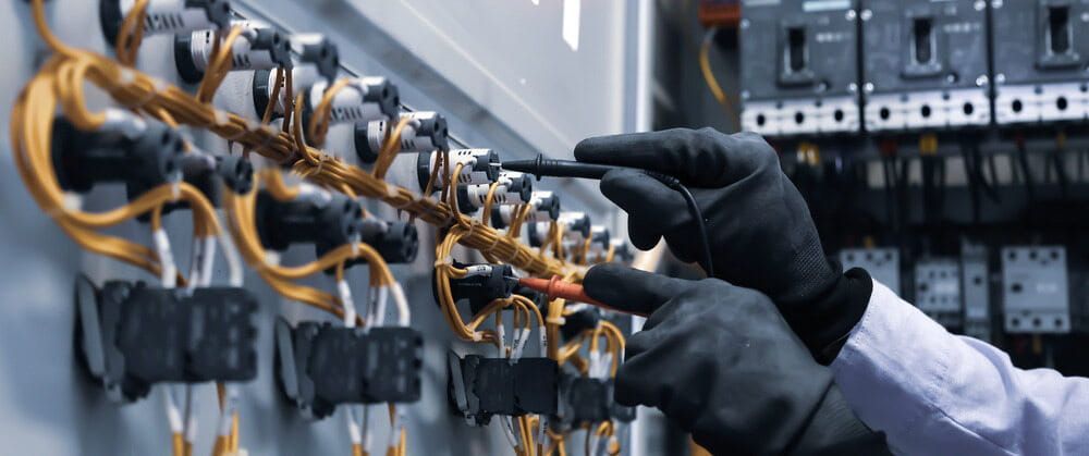 Electrician Wearing Gloves Working on Electrical Wiring — FAW Electrical in St Georges Basin, NSW