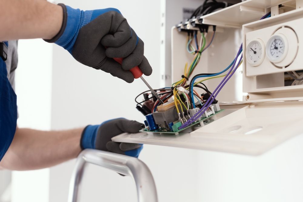 Person Using a Screwdriver to Repair Electrical Components — FAW Electrical in Nowra Hill, NSW
