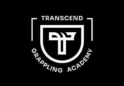 Transcend Grappling Academy logo in white on black, with a shield and stylized grappling emblem