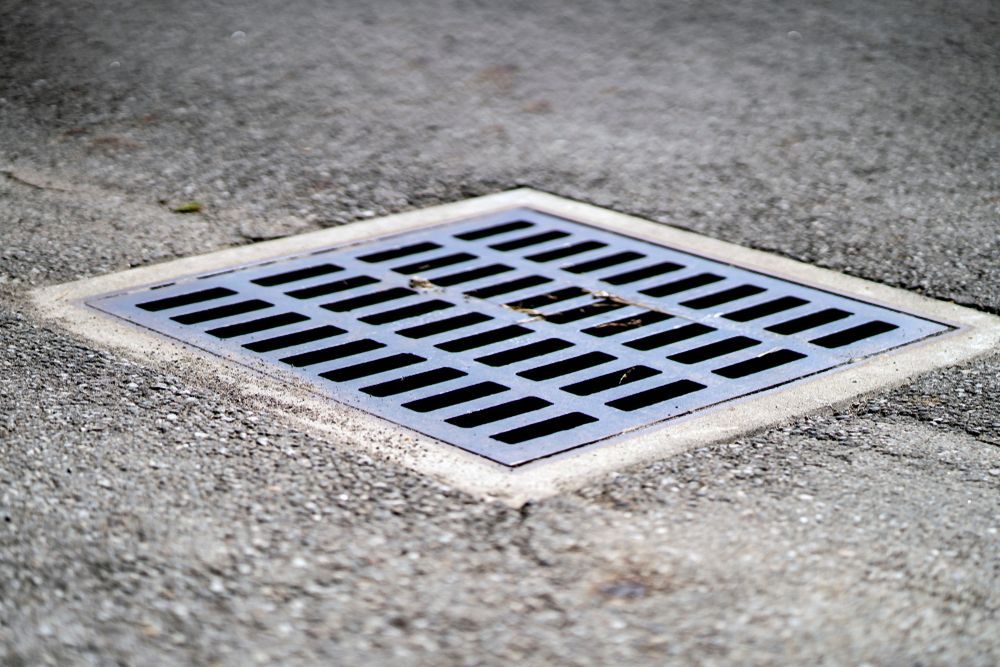 Square Metal Drain In Pavement — David Talbot Plumbing in Cranbrook, QLD