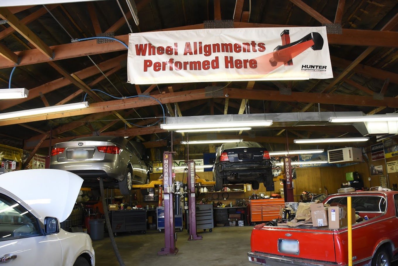 A garage with a sign that says wheel alignments performed here