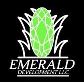 Logo for Emerald Development LLC with a green emerald and white grass-like outline on a black background