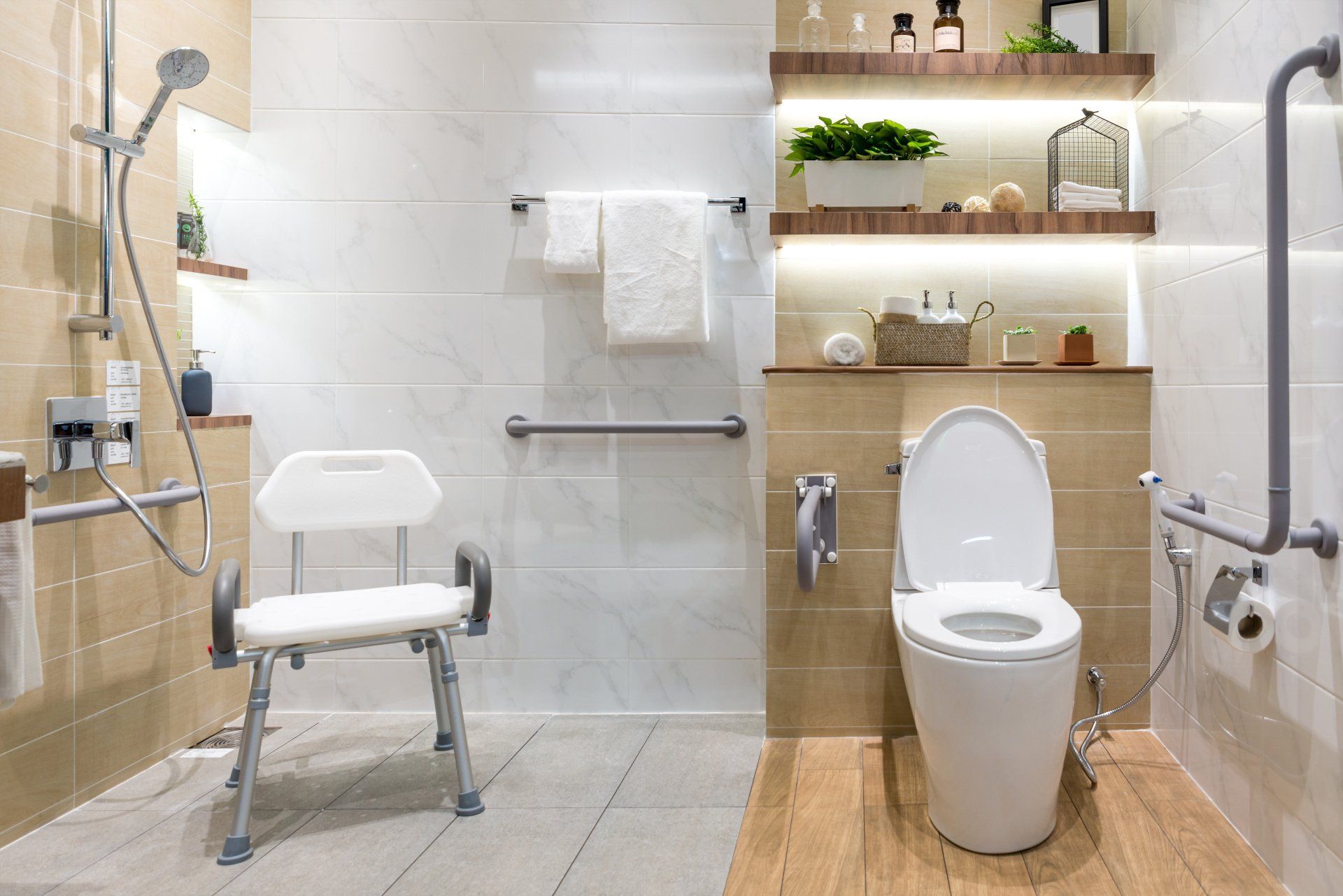 a bathroom with a toilet , shower , and chair .