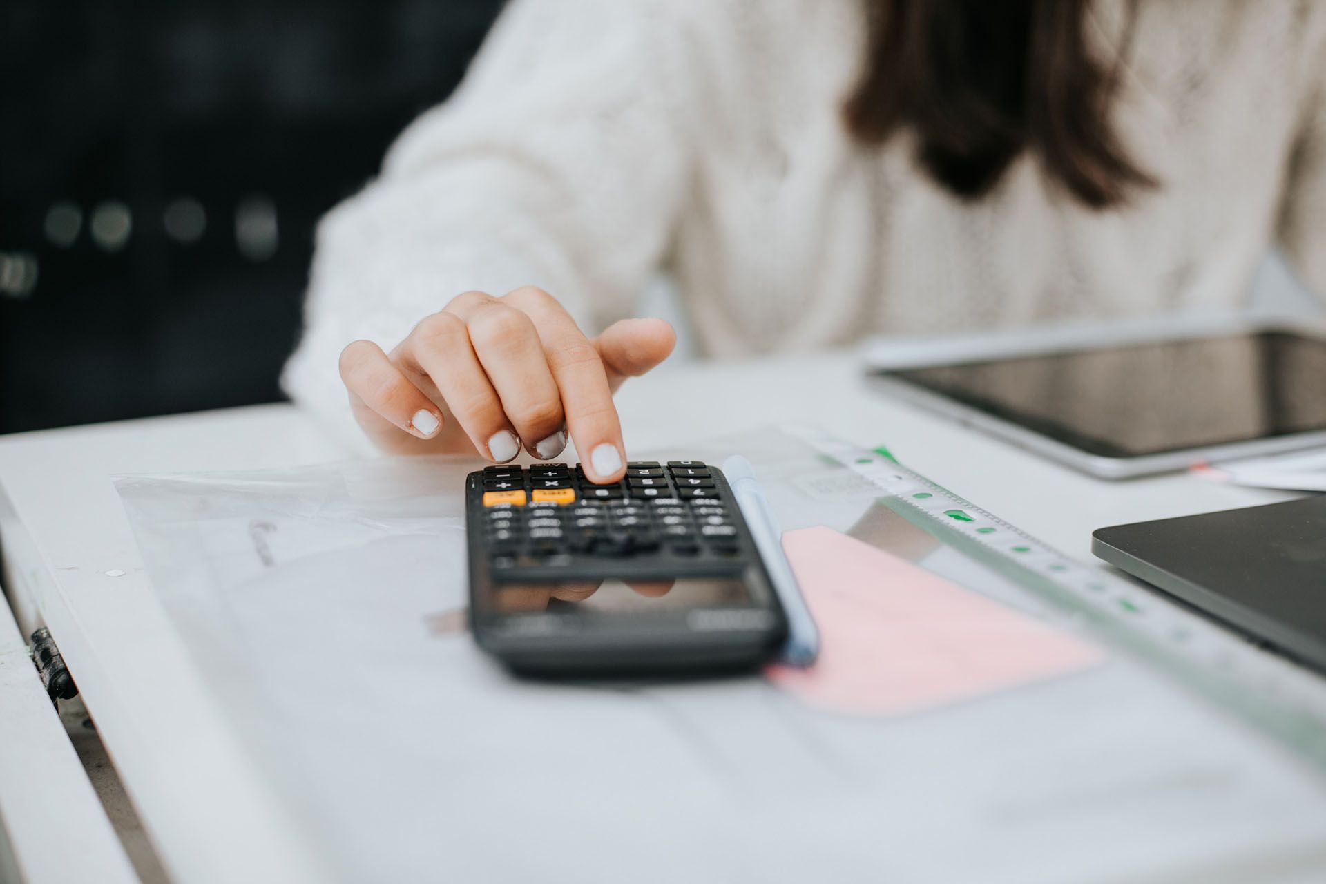 Woman Using a Calculator — Springdale, AR — LFG: Special Needs Division