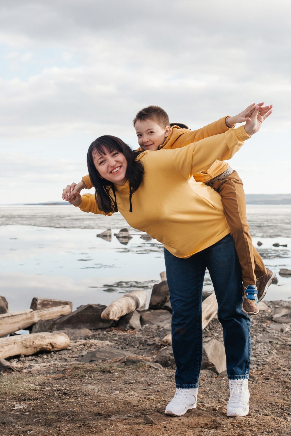 Mom and son grinning on beach