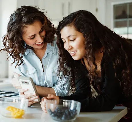 Mother and daughter looking at phone