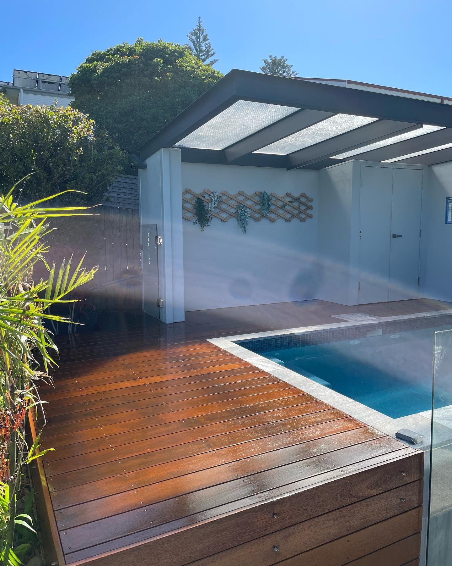 A Swimming Pool With a Wooden Deck in Front — Karl Witt Painter & Decorator In Albion Park, NSW