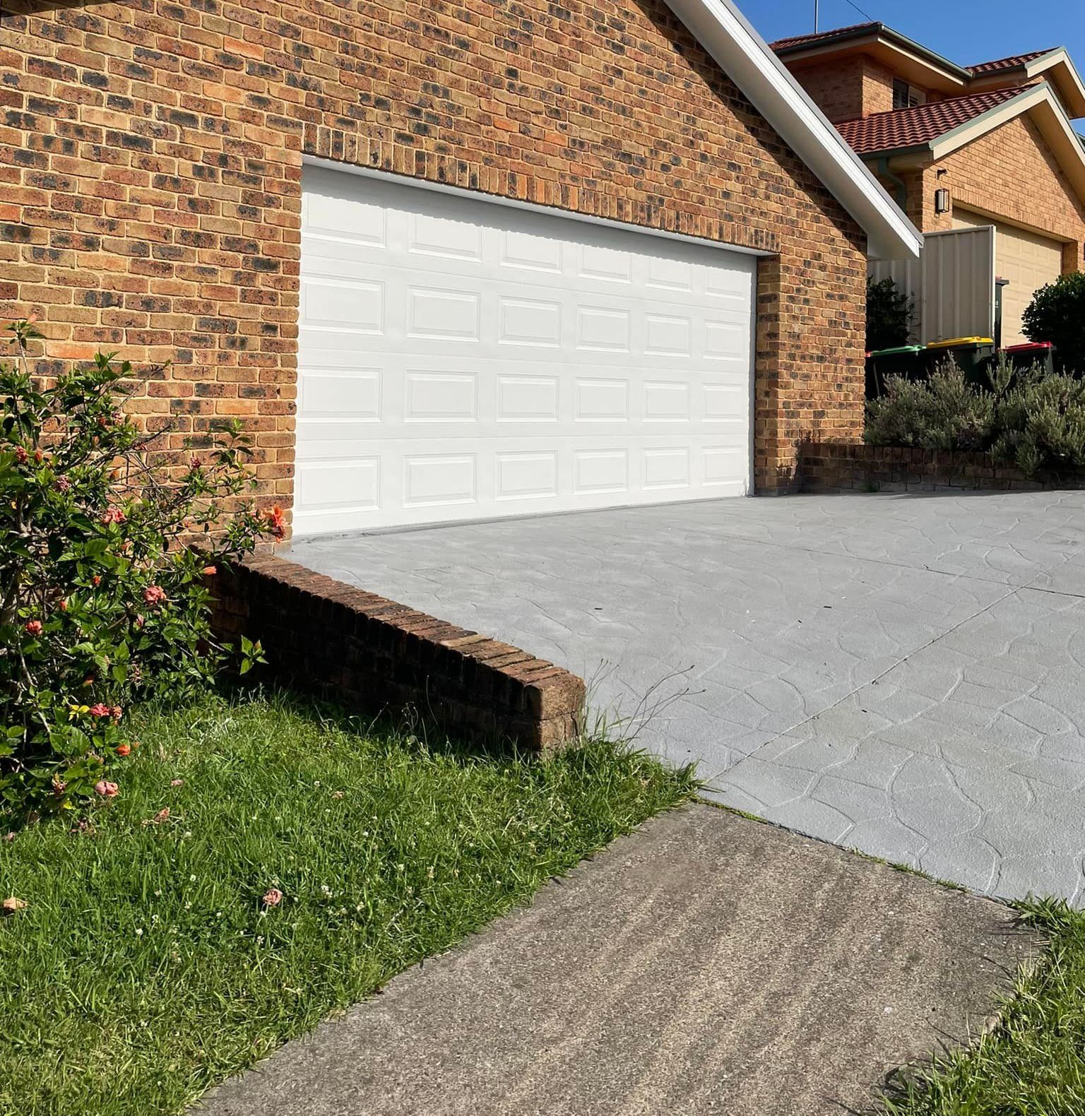A Brick House With Grey Driveway — Karl Witt Painter & Decorator In Oak Flats, NSW