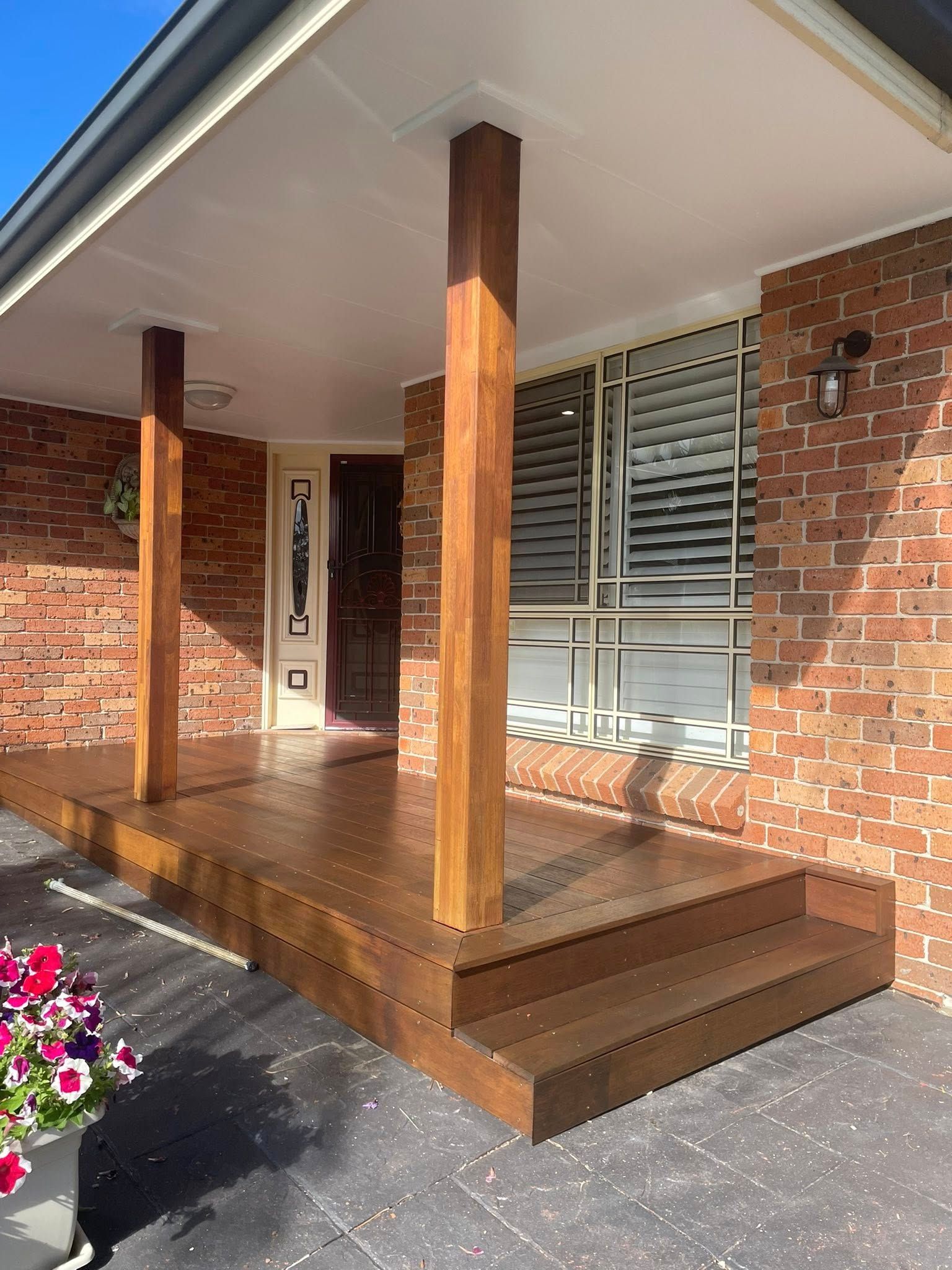 A Brick House With a Wooden Porch and Steps — Karl Witt Painter & Decorator In Kiama, NSW