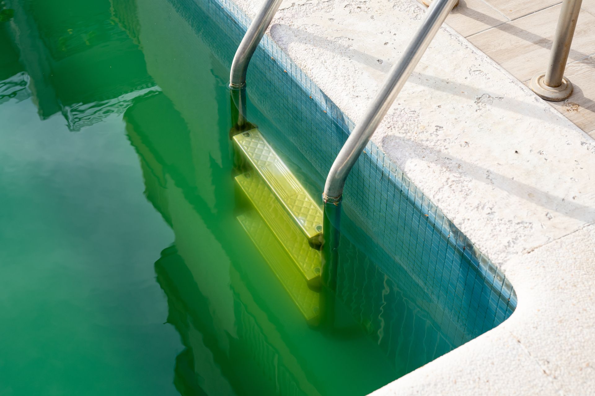 Residential pool with green water following storm and rainfall