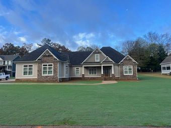 A large house with a large lawn in front of it.