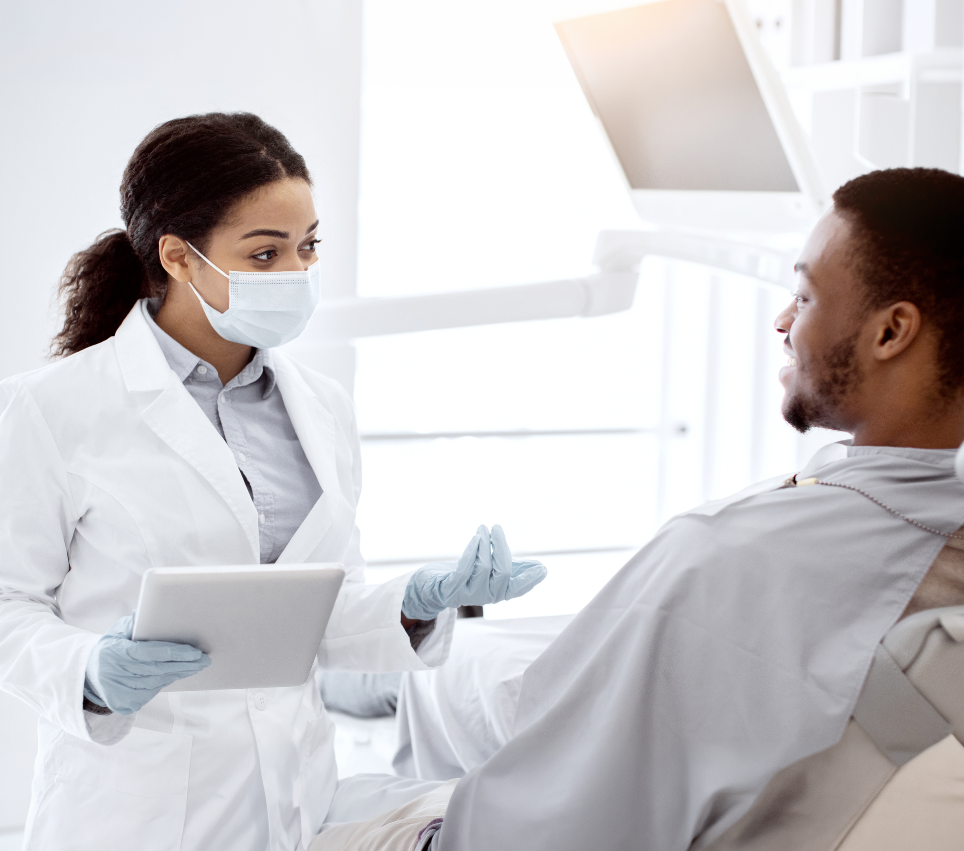 Experience the benefits of ozone therapy with a trusted biological dentist in Boise, ID A woman in a bathrobe is sitting in a chair with a syringe in her arm.