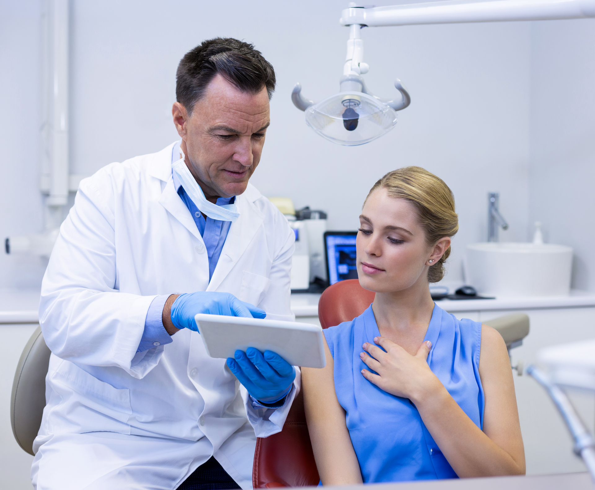 Experience the benefits of ozone therapy with a trusted biological dentist in Boise, ID A woman in a bathrobe is sitting in a chair with a syringe in her arm.
