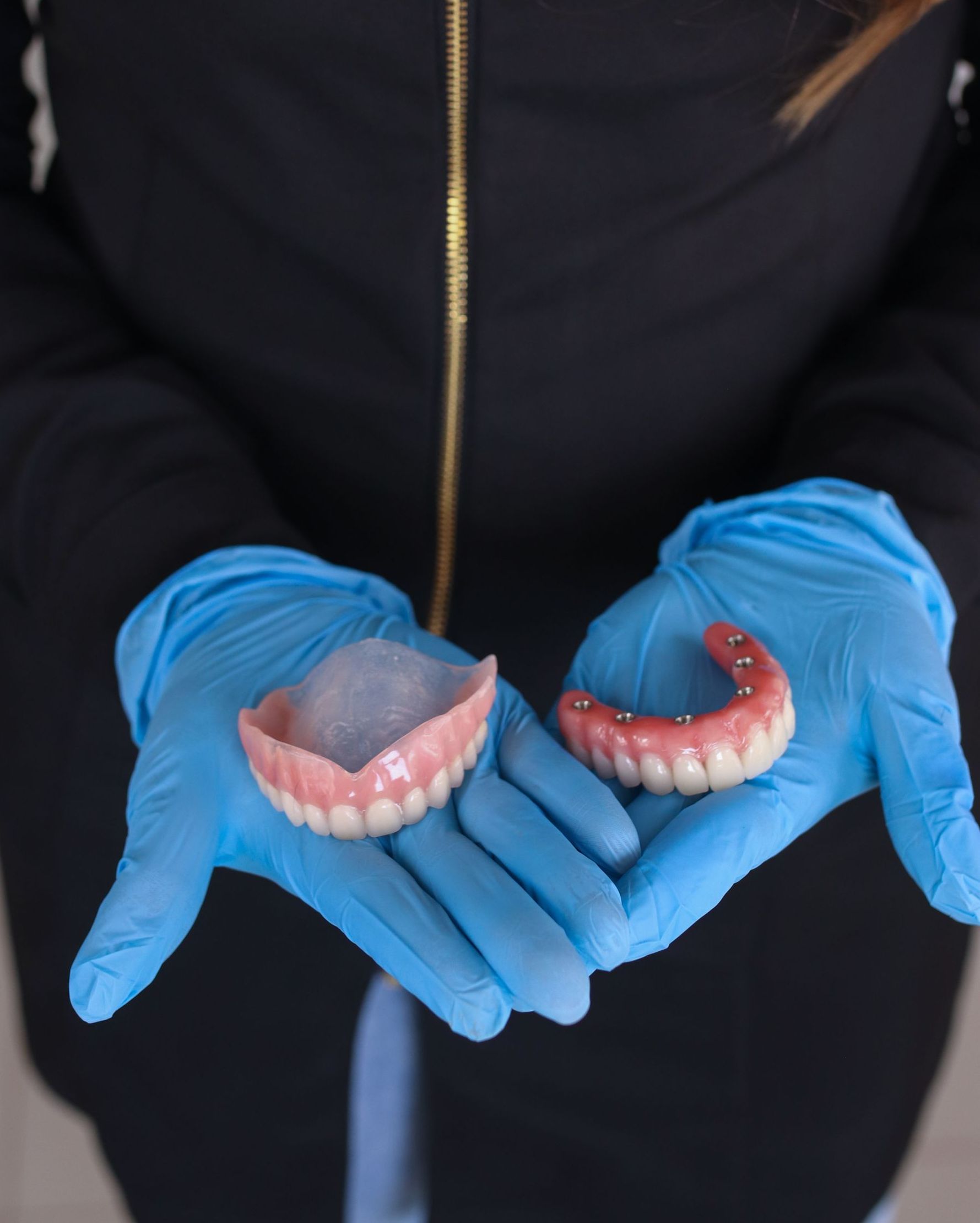 Full and Partial Dentures in Boise and Eagle, ID Dentist holding dentures in both hands | Full and Partial Dentures in Boise and Eagle, ID