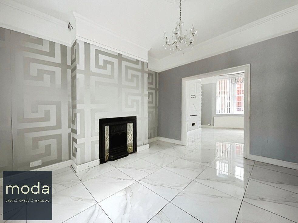 Empty living room with white marble flooring, fireplace, and silver patterned wallpaper.