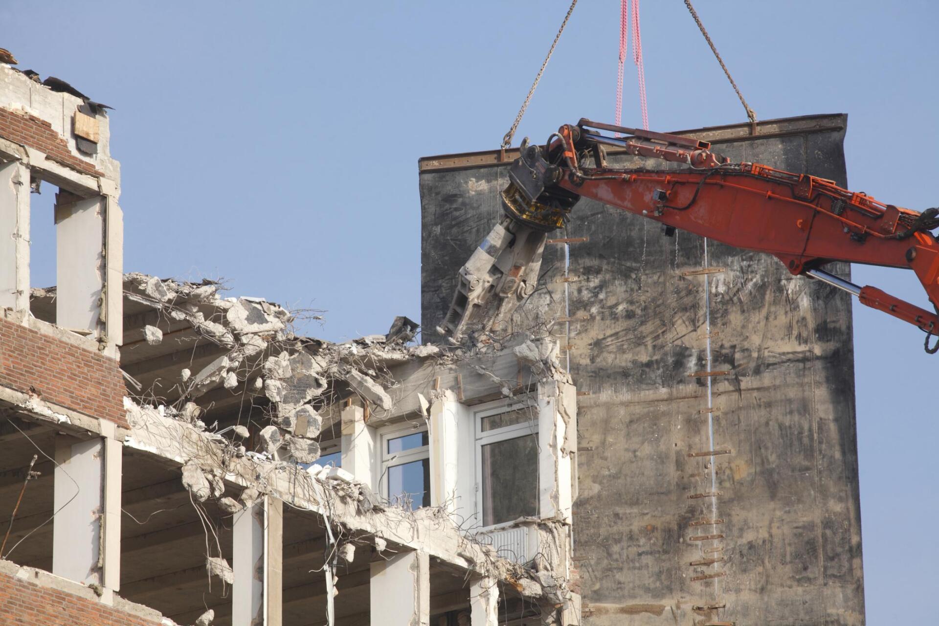 excavator destroying the building