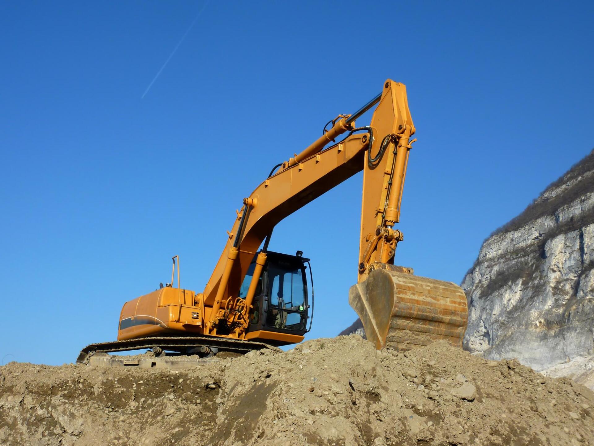 yellow excavator above the ground