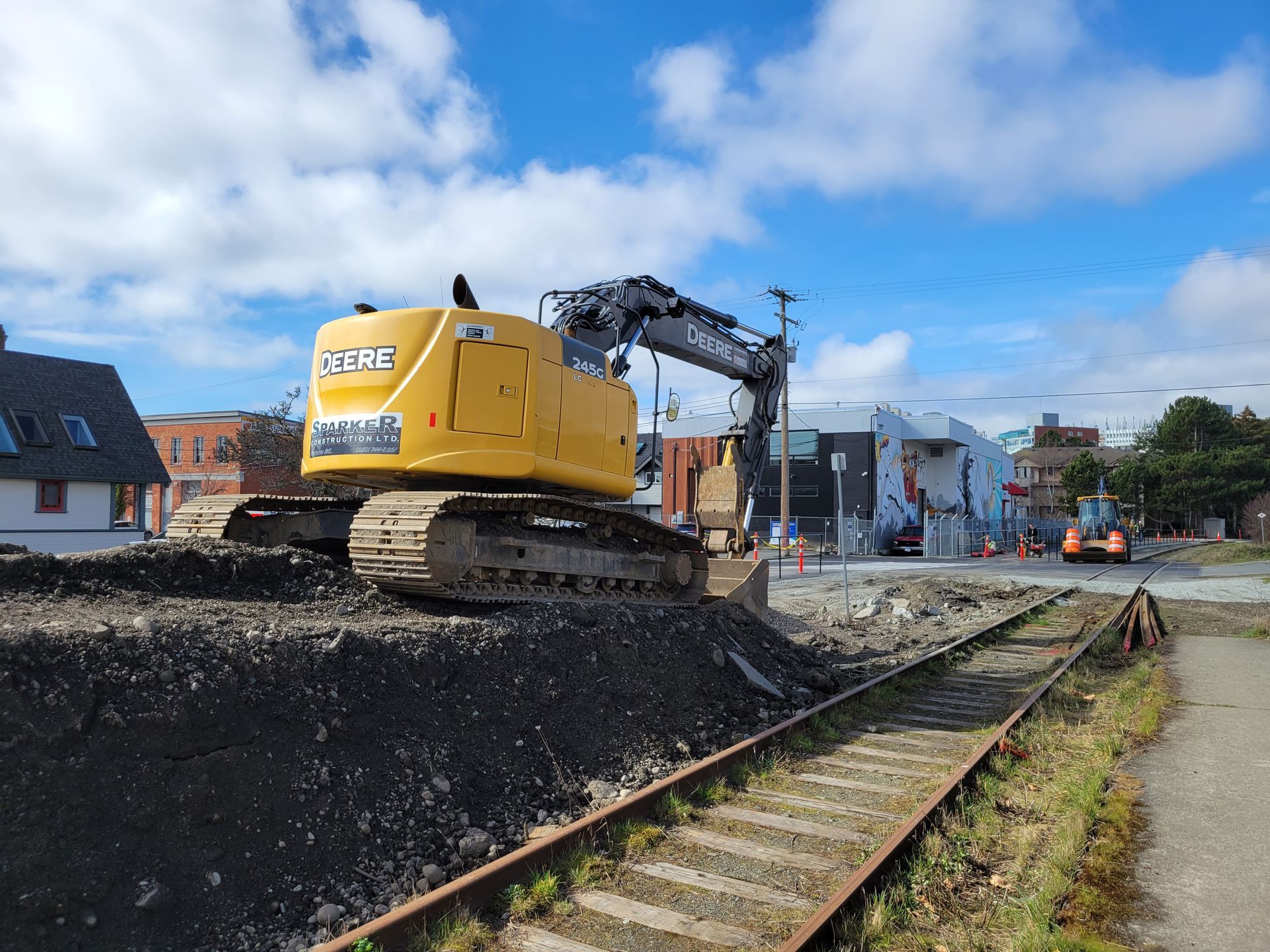 midsized excavator on a pile of dirt